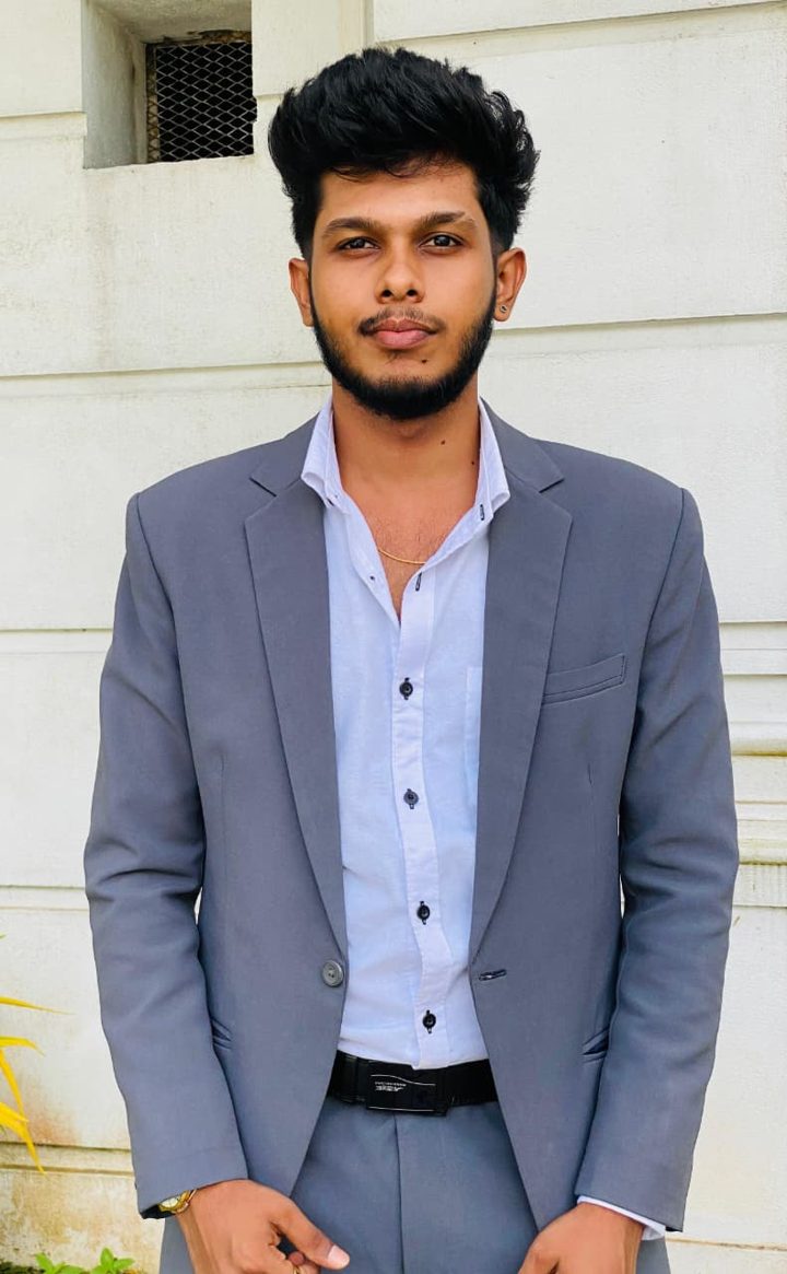 Portrait of Ashan Dulara in a grey suit